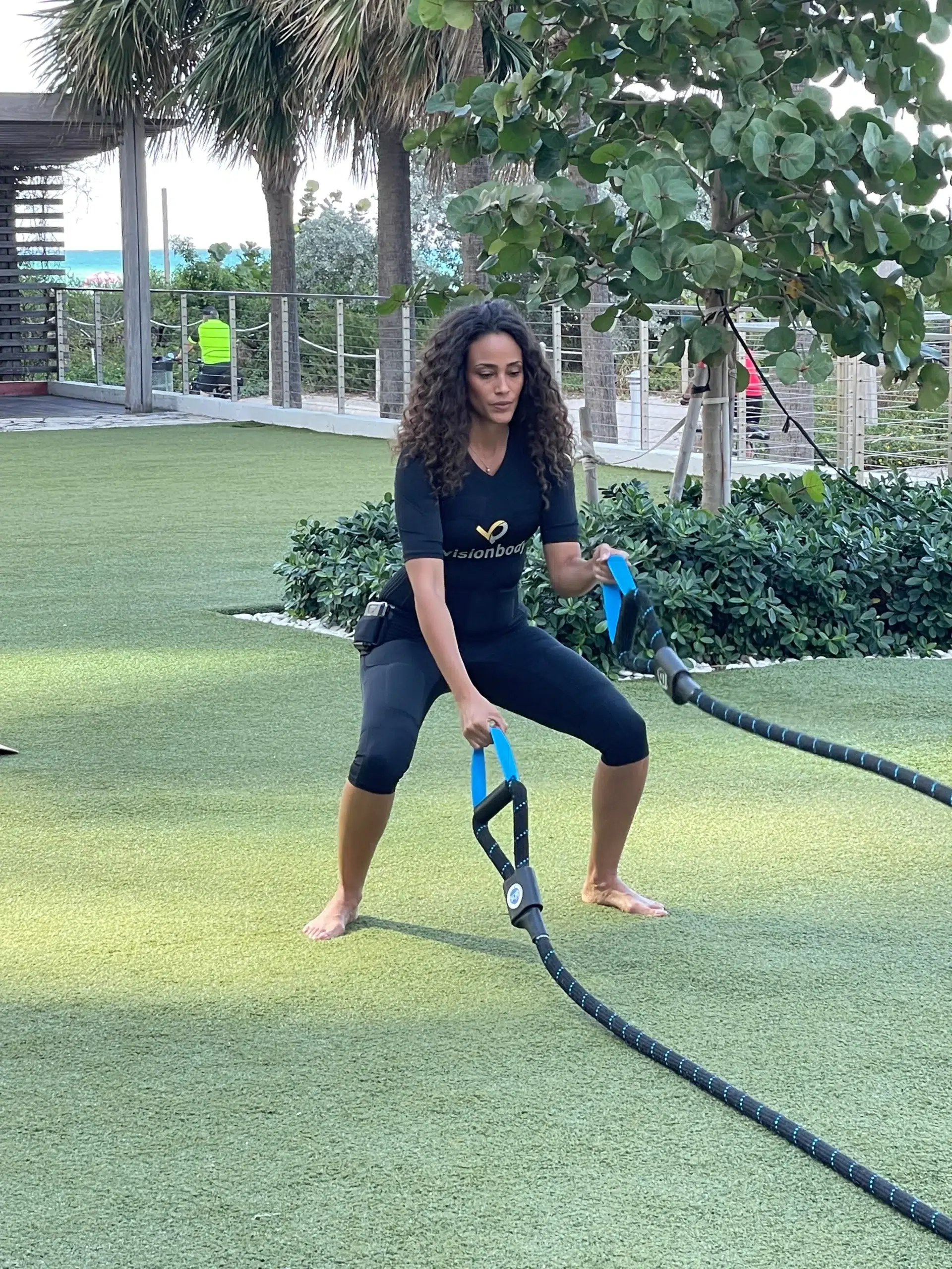 A woman exercising using battle ropes for weight loss.