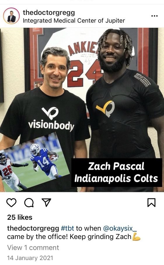 Two men posing for a photo wearing "visionbody" shirt